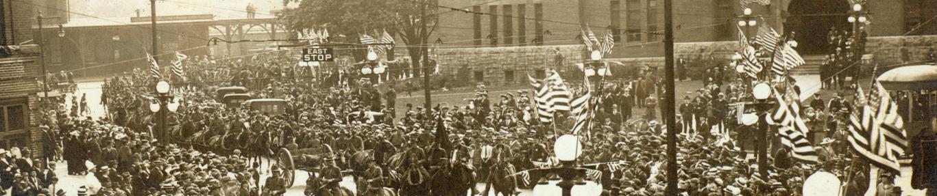 sepia photograph of crowd on street